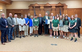 Elizabeth Cater presented with a Resolution adopted by Commissioners Court with classmates and CampV representatives