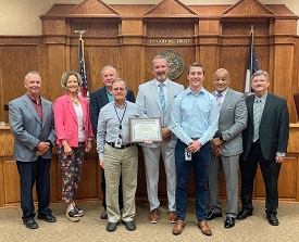 Smith County GIS Employees Phil Burkhart and Ethan Robinson stand with Chief Information Technology Officer Don Bell, Smith County Judge and Commissioners, with National Association of Counties Award.