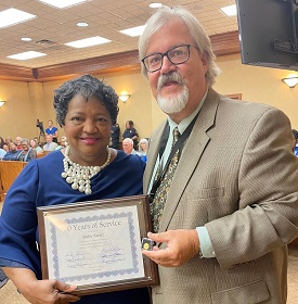 Ruby Saenz receives award for 20 years of service from Ross Worley