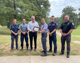 County Judge and Emergency Management Coordinator present Community Hero Award to leaders at the International ALERT Academy.