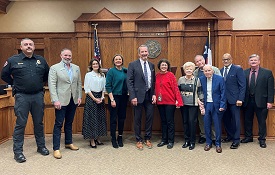 Hawkins Family members standing with Commissioners Court members